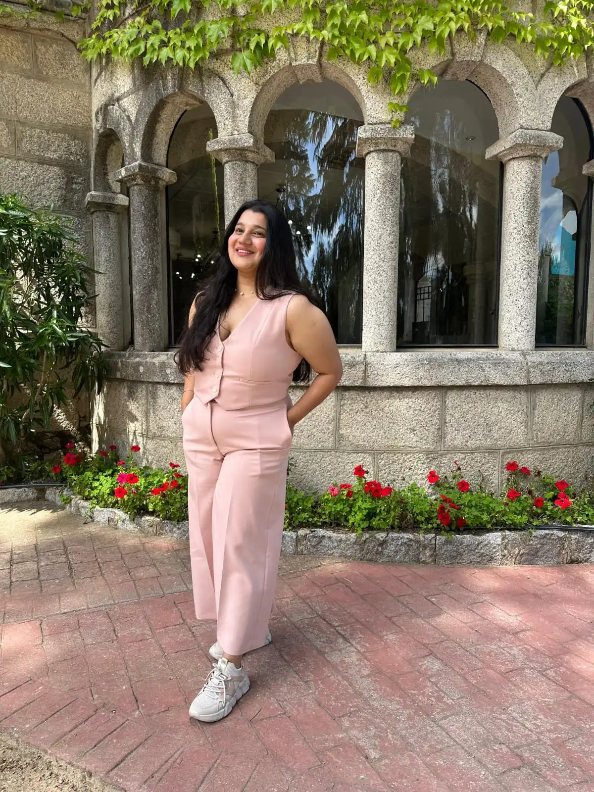 Preeti standing outside a stone building in Spain